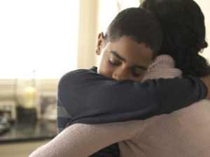teen hugging an adult relative