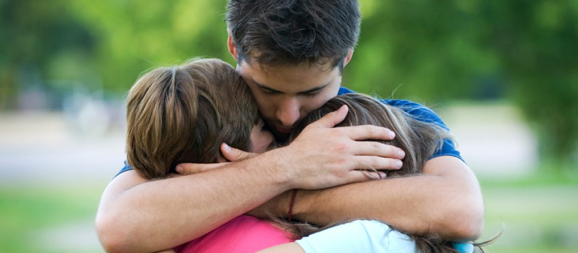 father-hugging-children